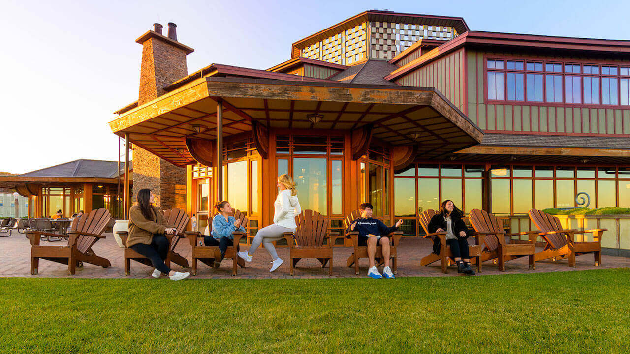 Students sit outside the Rocky Top Student Center on a beautiful fall evening.